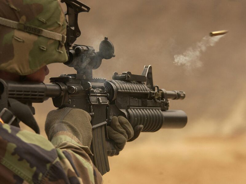 Soldier firing rifle with shell casing ejecting
